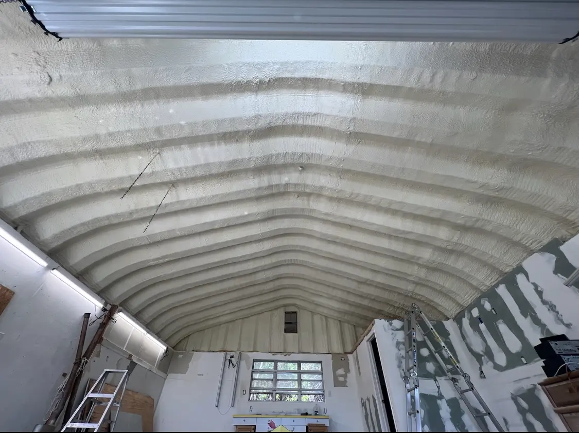Spray polyurethane foam applied to the underside of a metal roof deck in Bullskin